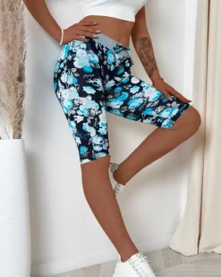 Spodenki 3/4|Krótkie Spodenki^Royalfashion Ciemnoniebieskie damskie spodenki 3/4 z kwiatowym wzorem Ecru