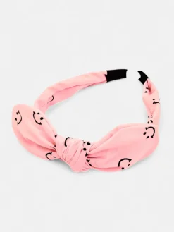 Akcesoria Do Włosów^Royalfashion Dziecięca opaska do włosów z kokardką z printem w uśmiechnięte buźki różowy
