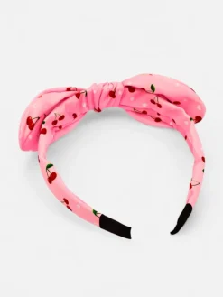 Akcesoria Do Włosów^Royalfashion Dziecięca opaska do włosów z kokardką z printem w wisienki różowy
