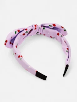 Akcesoria Do Włosów^Royalfashion Dziecięca opaska do włosów z kokardką z printem w wisienki fioletowy