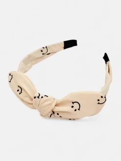 Akcesoria Do Włosów^Royalfashion Dziecięca opaska do włosów z kokardką z printem w uśmiechnięte buźki krem