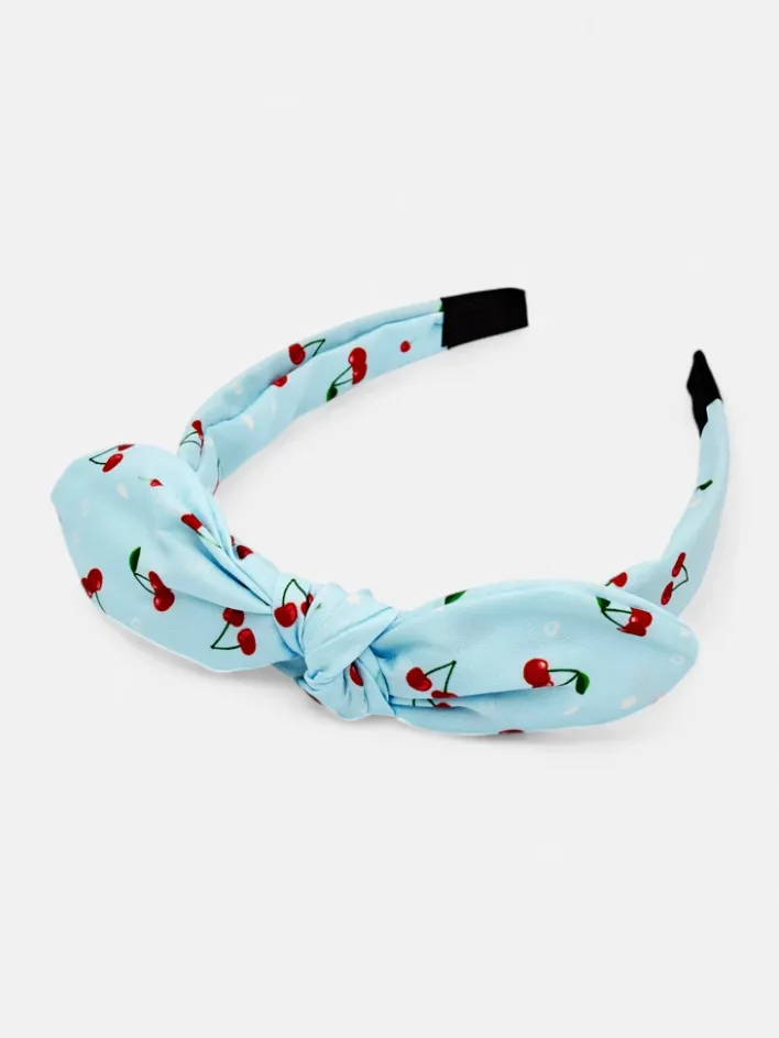 Akcesoria Do Włosów^Royalfashion Dziecięca opaska do włosów z kokardką z printem w wisienki niebieski