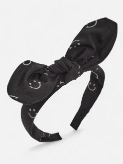 Akcesoria Do Włosów^Royalfashion Dziecięca opaska do włosów z kokardką z printem w uśmiechnięte buźki czarny