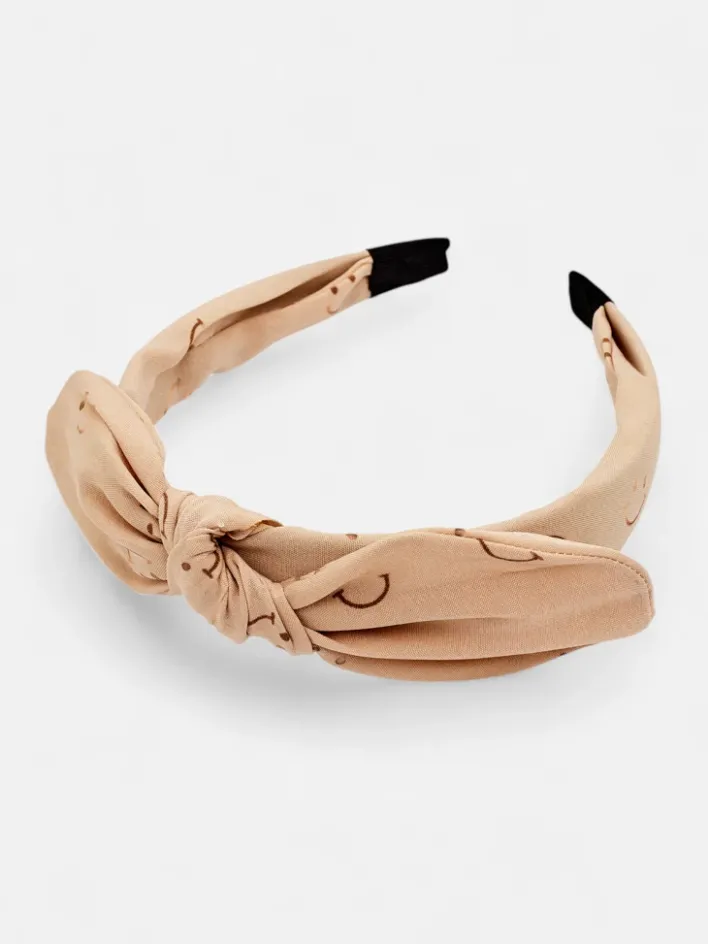 Akcesoria Do Włosów^Royalfashion Dziecięca opaska do włosów z kokardką z printem w uśmiechnięte buźki beżowy