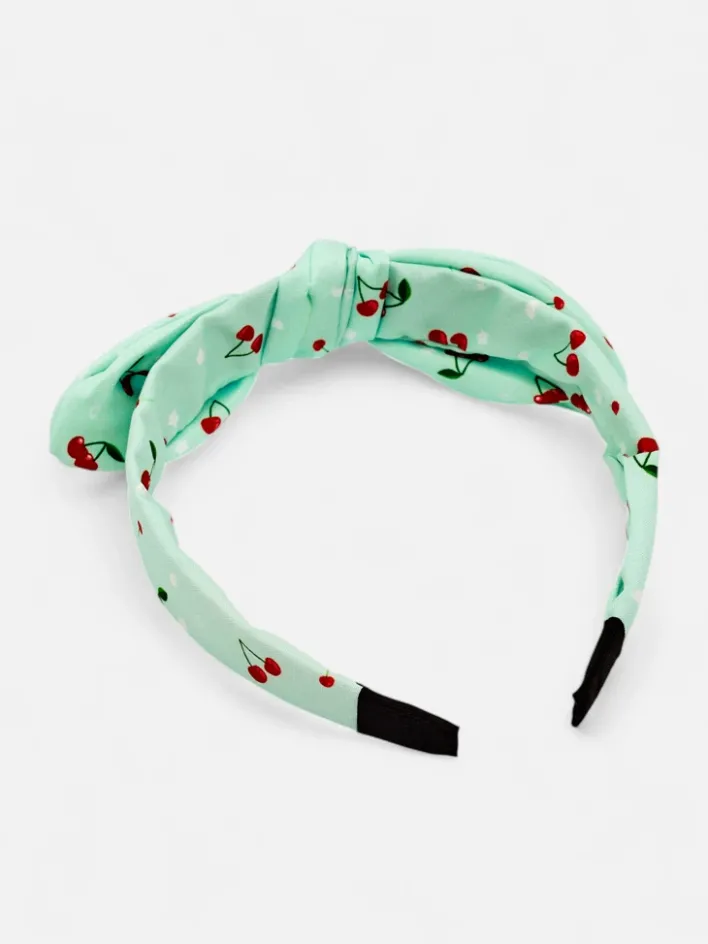 Akcesoria Do Włosów^Royalfashion Dziecięca opaska do włosów z kokardką z printem w wisienki mięta