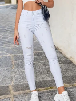 Jeansy^Royalfashion Jeansy damskie rurki z przetarciami