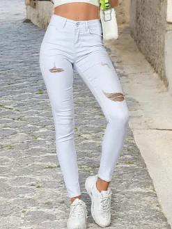 Jeansy^Royalfashion Jeansy damskie typu rurki z przetarciami