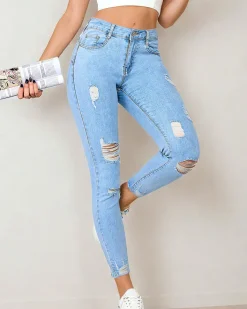 Jeansy^Royalfashion Jeansy damskie typu rurki z przetarciami