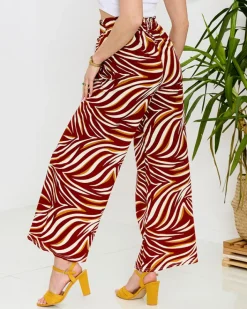 Spodnie Materiałowe^Royalfashion Wzorzyste spodnie damskie typu palazzo w kolorze m czerwony